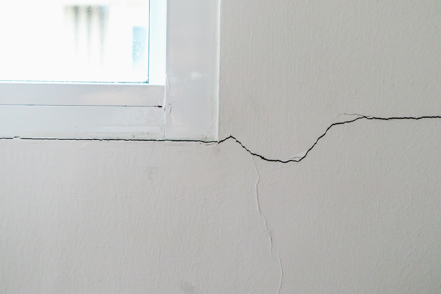 signs of foundation trouble window hairline crack