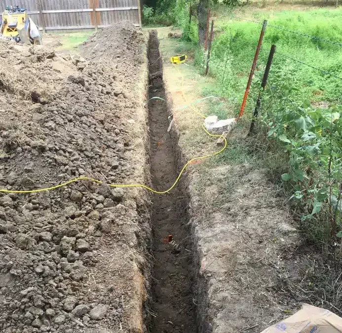 close up of trench dug up for foundation drainage